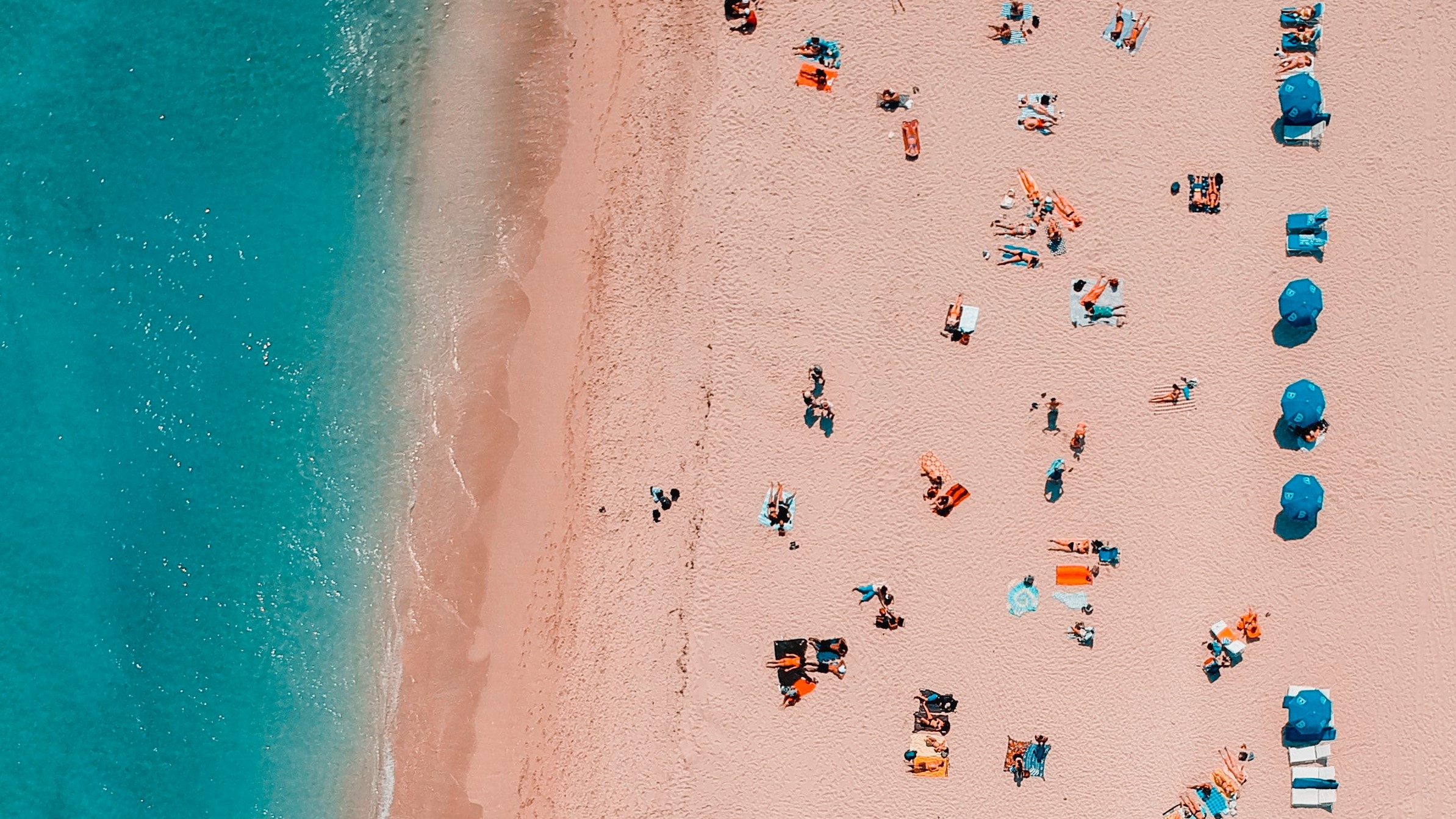 Bird's eye view of people relaxing on a beach.